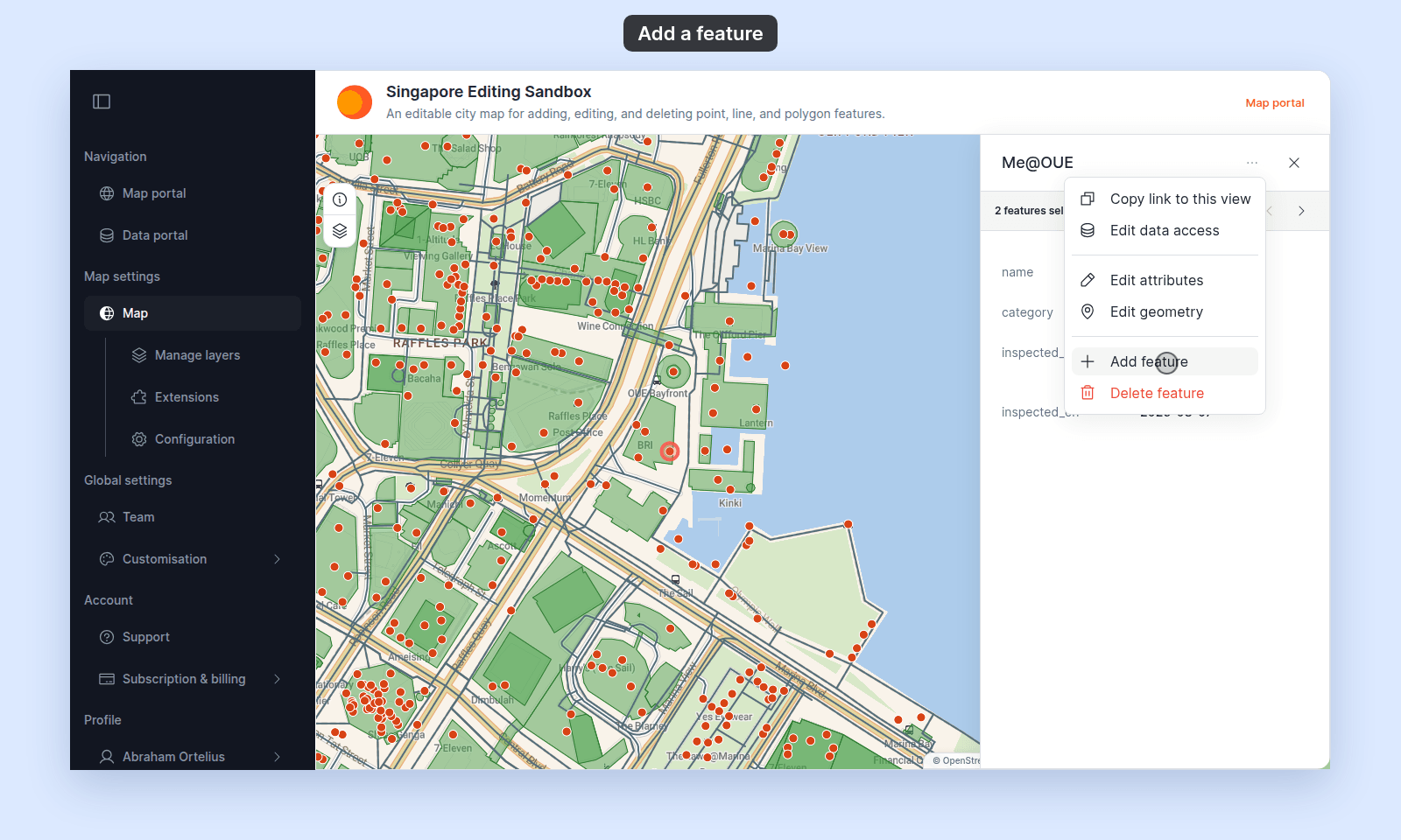 Popup of the Me@OUE place with its three-dot menu open. The menu lists Copy link to this view, Edit data access, Edit attributes, Edit geometry, Add feature, and Delete feature, and the pointer is on Add feature. Share and Bookmark are not listed because the map's Share and bookmark tool is off